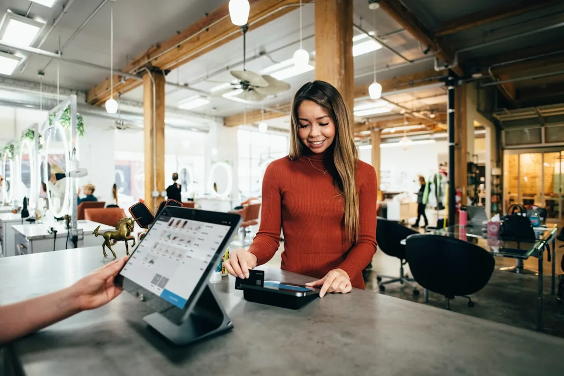 A Colorado small business owner welcoming a customer at the counter